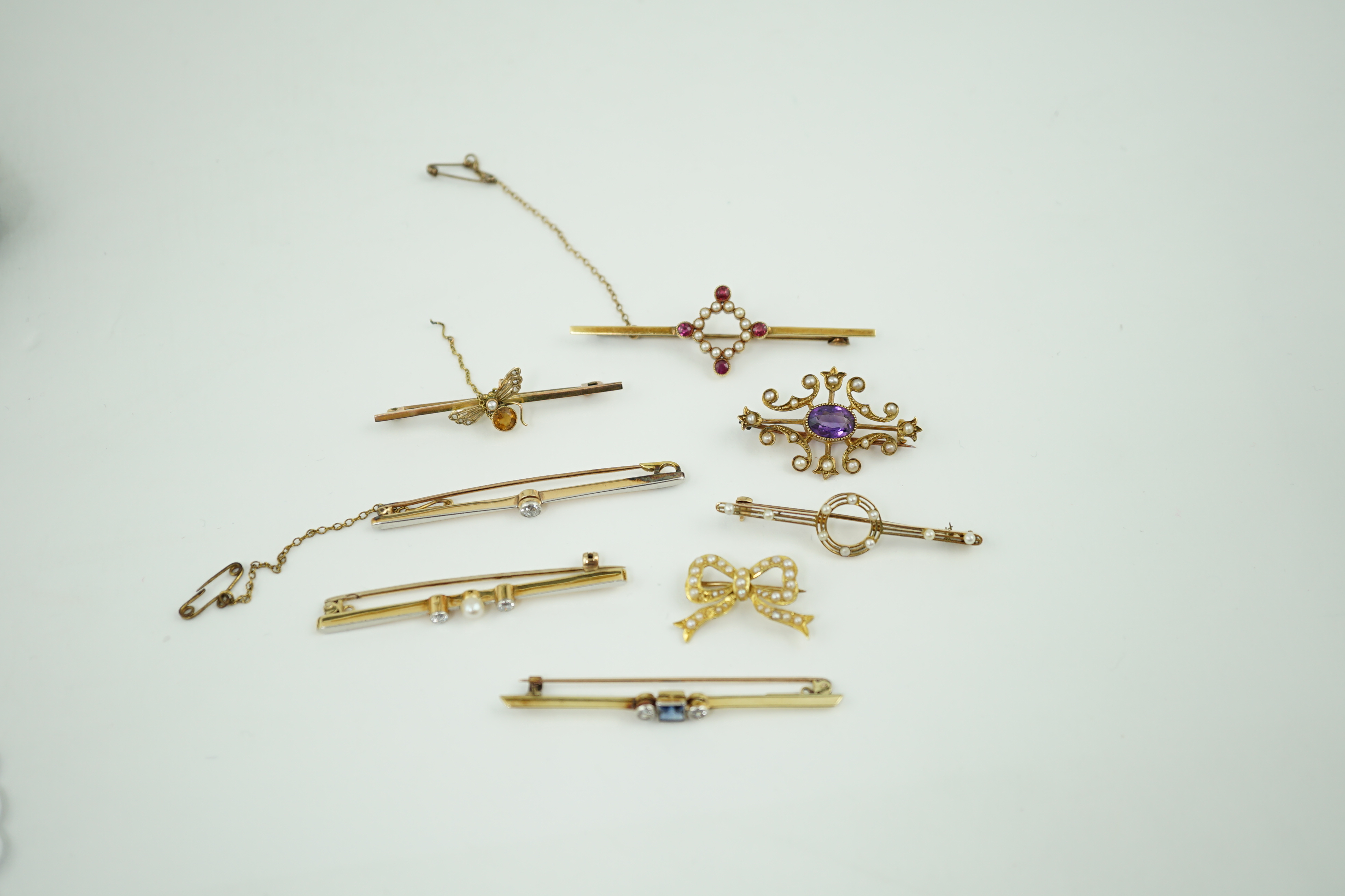 Five assorted Edwardian bar brooches, including a 15ct gold sapphire and diamond set three stone, a diamond and seed pearl, ruby? and seed pearl, a solitaire diamond set and a seed pearl and citrine bug brooch